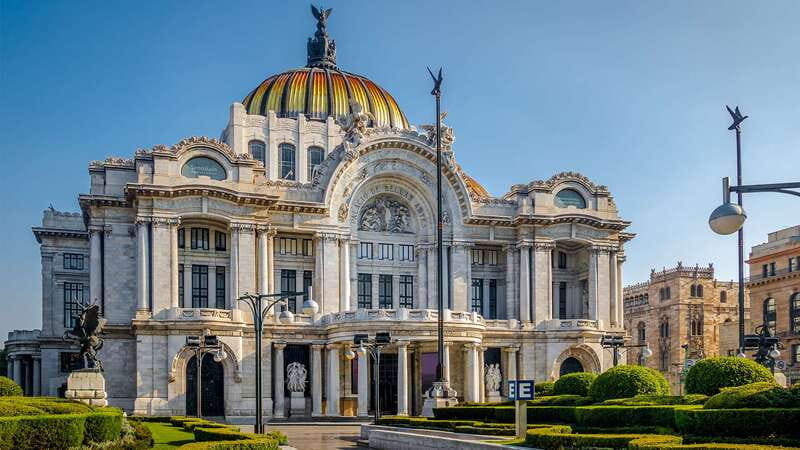 The Palacio de Bellas Artes above the trees on Avenida Juarez